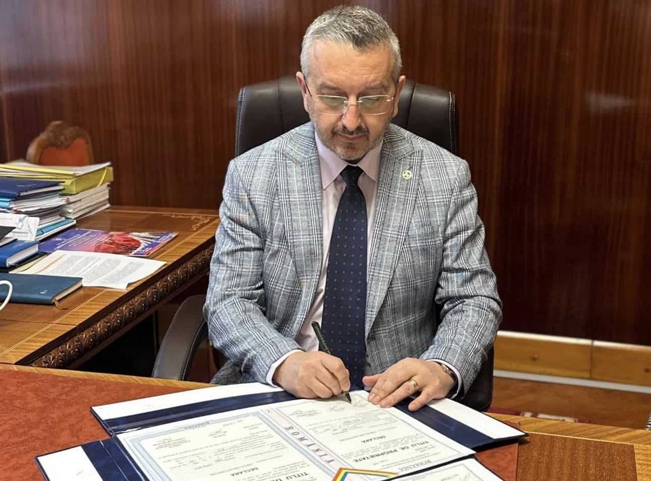 Bărbat semnând documente oficiale pentru atribuirea terenurilor în Alba.