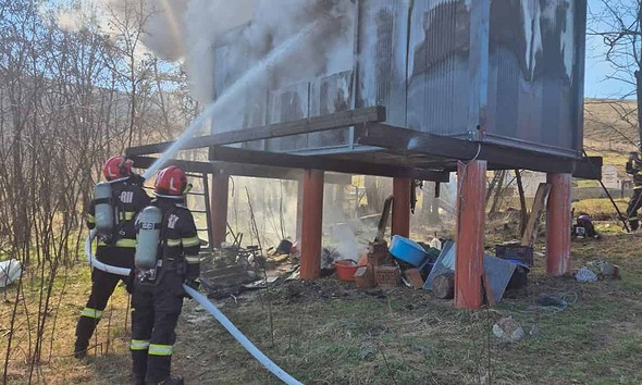 Pompieri stingând focul de la containerul modular din Săsciori.